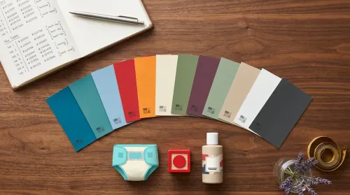 Flat-lay on the psychology of color in marketing and branding — paint chips, hex notebook, family-product samples